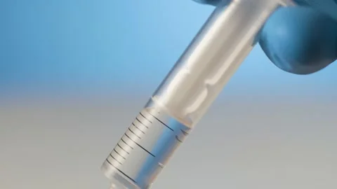 Extreme close-up liquid in syringe injection needle, concept getting a shot Stock Footage 238498164