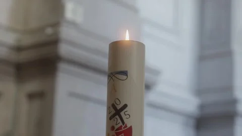 Extreme close up of a lit paschal candle in a church Stock Footage 332976338