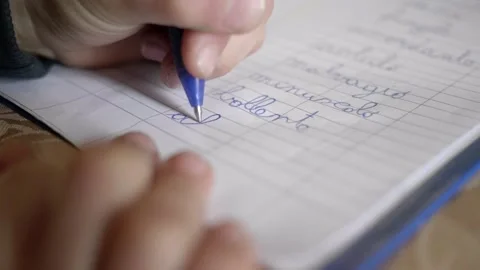 Extreme close up little boy learns to write. Video stock 154582154