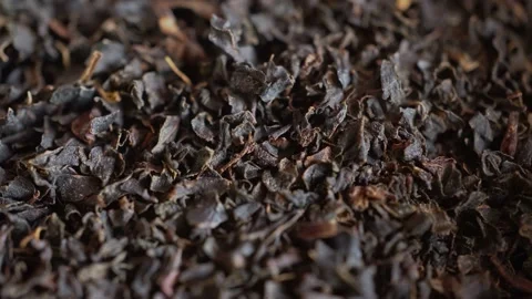 Extreme close up macro black tea rotation Stock Footage 229454961
