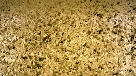 Extreme close up macro on a instant tea grains, dissolves in moving hot water Stock Footage 144431546