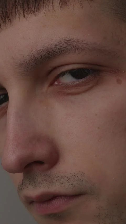 Extreme close up macro portrait of a young man eye looking away Stock Footage 335082372