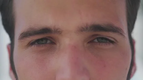 Extreme close-up macro portrait of a young man staring intensely and direct.. 스톡 동영상 347900925