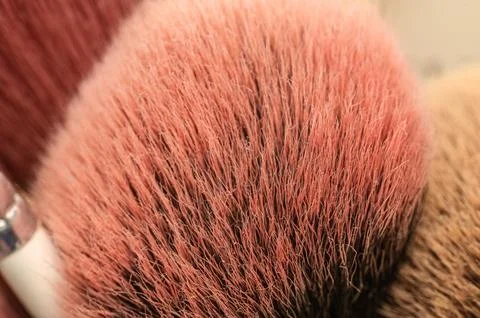 Extreme close-up macro shot of soft pink makeup brushes with fine bristles 스톡 사진