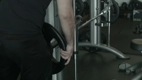 Extreme Close Up of a Man Adding Weights to a Machine at the Gym Stock Footage 233946309