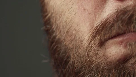 Extreme close up of man with beard being nervous and anxious. Biting his lip Stock Footage 93079192