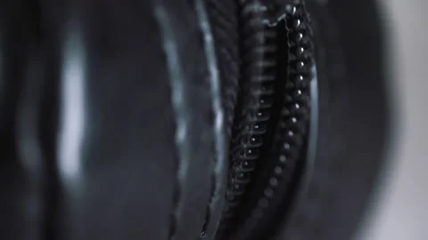 Extreme Close-up of a man closing zipper on black small bag. blurred background Stock Footage 169979042