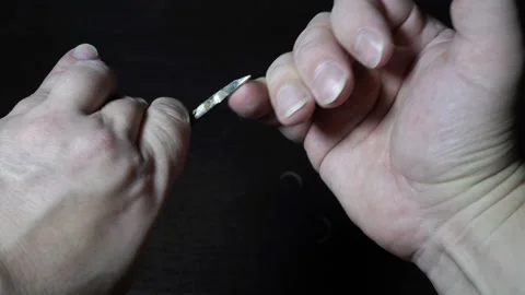 Extreme close-up, a man cuts long nails on his right hand with metal scissors 스톡 동영상 143143066