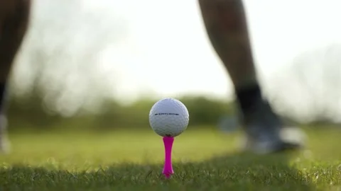 Extreme close-up of man driving golf ball off of a tee Stock Footage 189289636