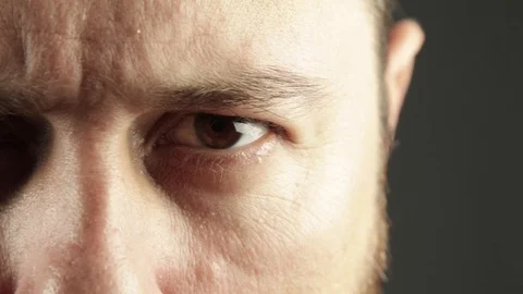 Extreme close up of man eye looking angry Stock Footage 93079158