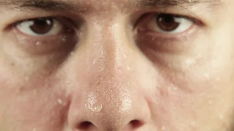 Extreme close up of man face covered in sweat Stock Footage 93079176