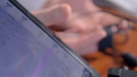 Extreme close up of man hands under lie detector test. 4K. Stock Footage 77137822