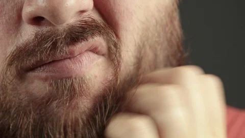 Extreme close up of man having a beard itch. Scratching his beard Stock Footage 93079189