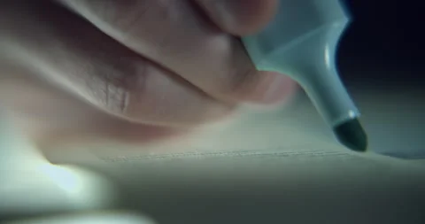 Extreme Close-Up of Man Highlighting Text with Blue Highlighter Stock Footage 343693757