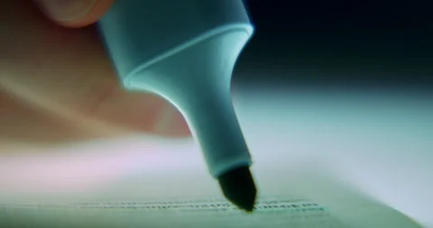 Extreme Close-Up of Man Highlighting Text with Blue Highlighter Stock Footage 343694264
