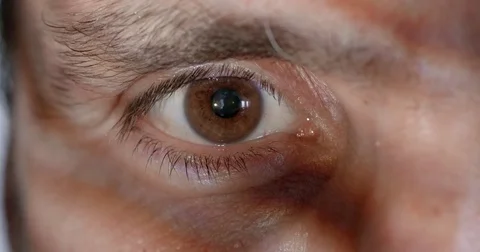 Extreme close up on man's brown eye with projected pattern 4K Stock Footage 79077714