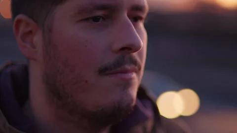 Extreme Close-Up of Man's Face, No Emotion, Highway at Dusk, Cars Passing, Slow Stock Footage 299266126