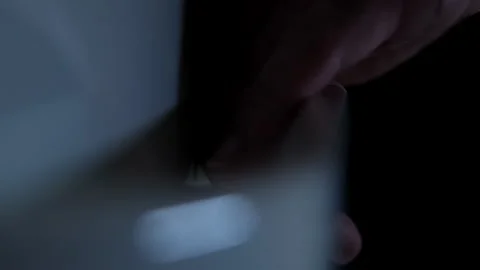 Extreme close-up of a man's hand opening a fridge door at night Video stock 250820123