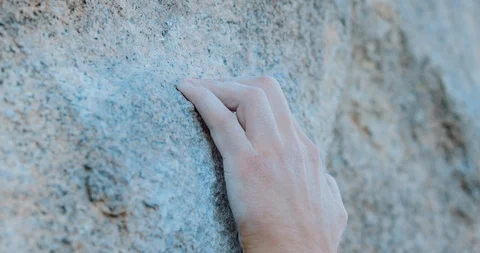 Extreme close up of mans hands reaching for tiny rock climbing holds Stock Footage 107694231