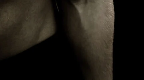 Extreme close up of mans shoulder doing arm curls Stock Footage 33831246