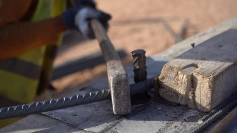 Extreme Close-Up of Manual Lever Tool Bending Steel Rebar at Construction Site Vídeos de archivo 334879186