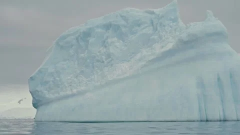 Extreme Close-Up of Massive Pale Blue Antarctic Icebergs With Smooth Striated 動画素材 333898559