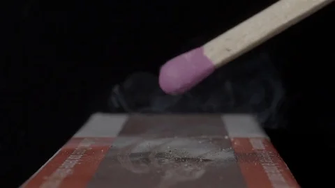 Extreme close up of a match being lit. Filmed in super slow motion. Macro lens. Stock Footage 75656642