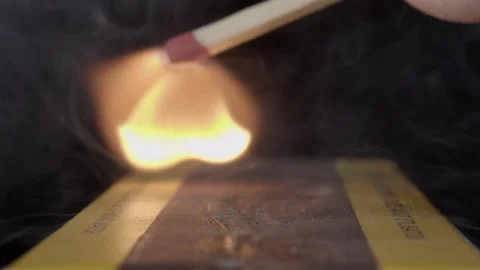 Extreme close up of a match being lit. Filmed in super slow motion. Macro lens. Stock Footage 75656790