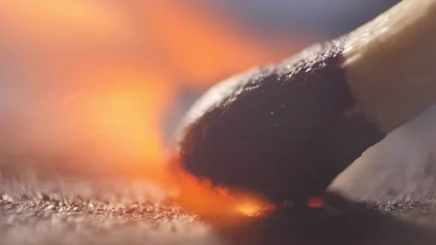 Extreme close up of a match lights in slow motion Stock Footage