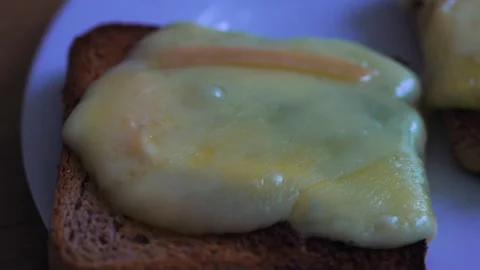 Extreme close up of melted cheese slice on toasted bread with smooth glossy.. Stock Footage 332302841