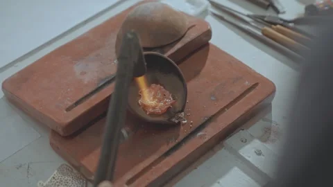 Extreme Close-up of Melting Raw Silver in a Ceramic Crucible with Gas Torch 動画素材 333733283