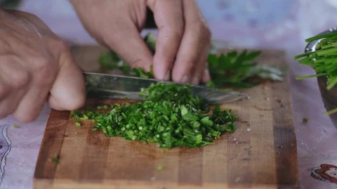 Extreme Close-up, Men Hands Cut Parsley for Salad on a Wooden Board Stock Footage 113119920