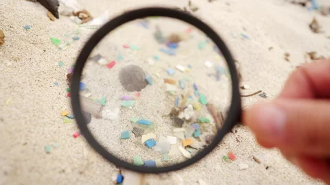 Extreme close-up of microplastic or small plastic particles in sand on a beach Stock Footage 306747060
