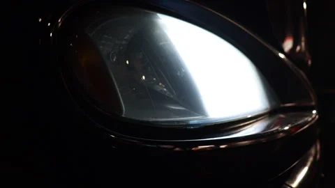 Extreme Close Up Of A Modern Car Headlight Igniting In The Dark. The Bright Main Stock Footage 319208634