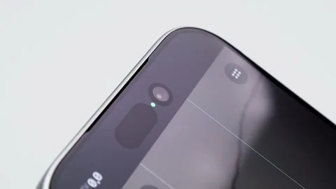 Extreme Close-up of Modern Smartphone Dynamic Island and Front Selfie Camera Stock Footage 329568104