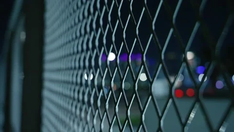 Extreme Close Up motion down along Diagonal Chain Link Fence at Night. Security Vídeos de archivo 343331034