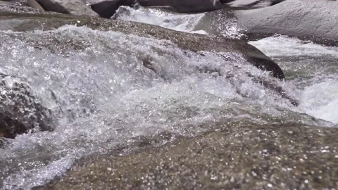 Extreme close up of mountain stream flowing down across stones. Stock Footage 130572271