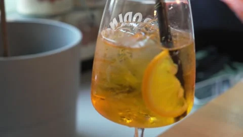 Extreme close-up moving shot of olives and a glass of Crodino Stock Footage 303772615