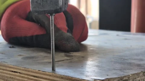 Extreme Close-up of Nail Being Driven into Wooden Formwork Video stock 332506487