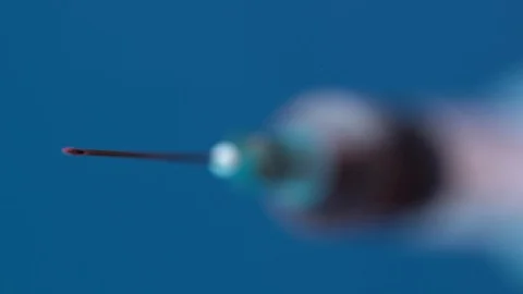 Extreme close up on a needle blue background Video stock 128343361