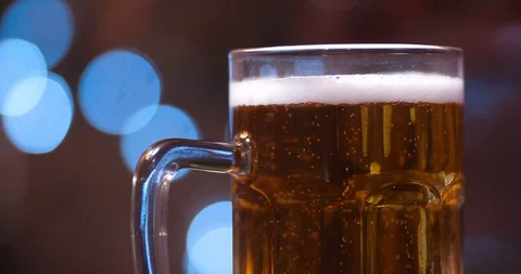 Extreme close up of one half liter glass mug full of beer with bubbles 動画素材 127090484