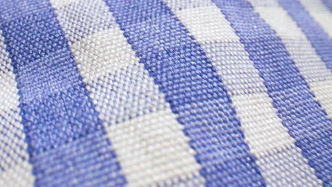 Extreme close up over blue and white checked fabric. Video stock 134981908