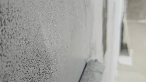 Extreme Close Up of Paint Roller Coating Textured Concrete Wall Stock Footage 342925394