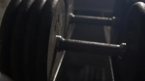 Extreme Close Up Pan Over The Top Of Weights Lined Up On Weight Rack  Stock Footage 123065799