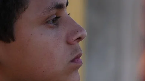 Extreme close up of a pensive young Hispanic man Stock Footage 80063873