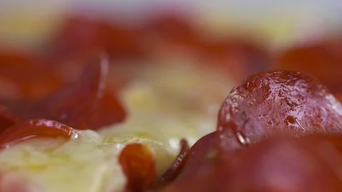 Extreme close up of a pepperoni pizza being cut. Stock Footage 72542279