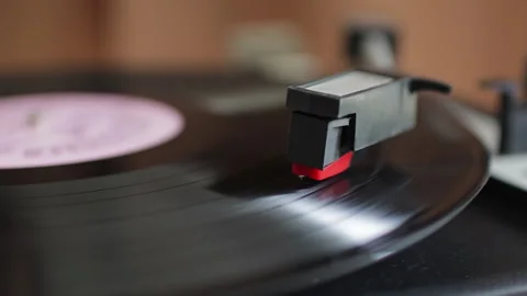 Extreme close-up of a phonograph needle dropping and riding in the grooves Stock Footage 320026905