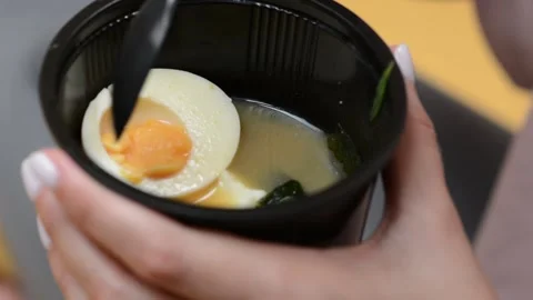 Extreme close-up of a plastic takeaway container filled with soup Vídeo Stock 346638169