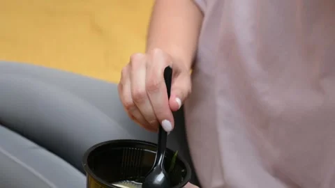 Extreme close-up of a plastic takeaway container filled with soup Video stock 346638195