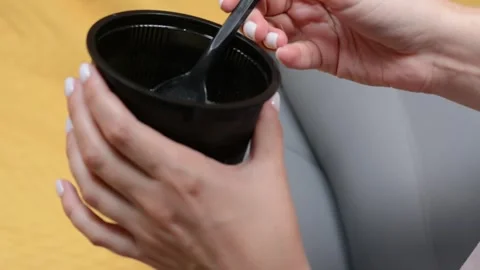Extreme close-up of a plastic takeaway container filled with soup Video stock 346638203
